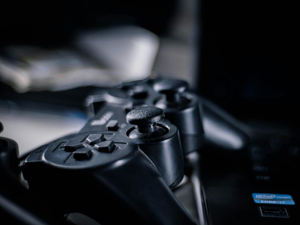 Close-up of a black gaming controller with buttons visible, ideal for tech themes.