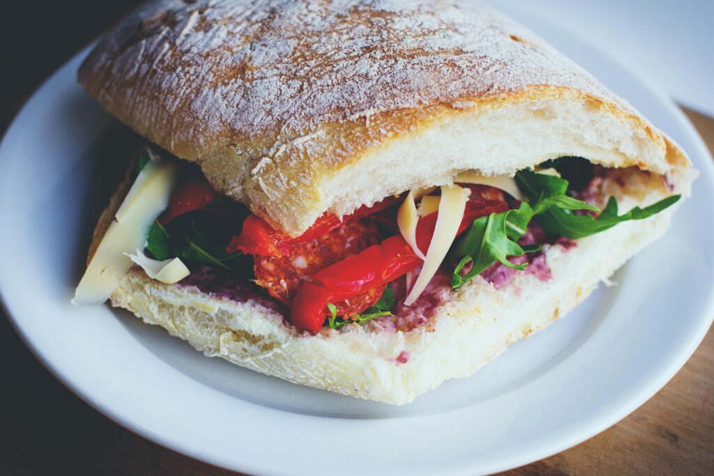 Delicious Mediterranean-style sandwich with fresh veggies on ciabatta bread. Perfect for a healthy meal.