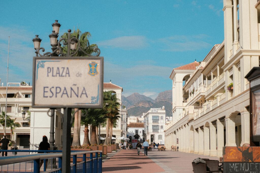 Picturesque view of Plaza de España in Nerja, Andalusia with distant mountains.