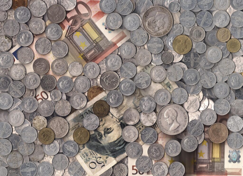 A collection of various European currency coins and notes in a scattered arrangement.
