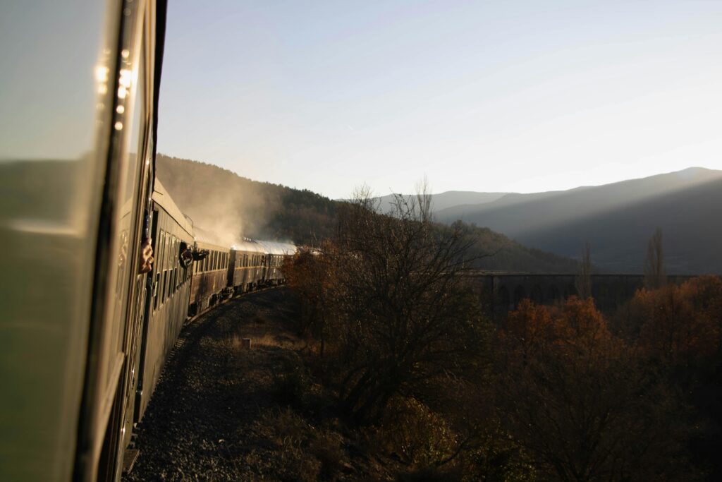Vintage train captures autumn sunset in Canfranc, Aragón. Rich history and scenic beauty.