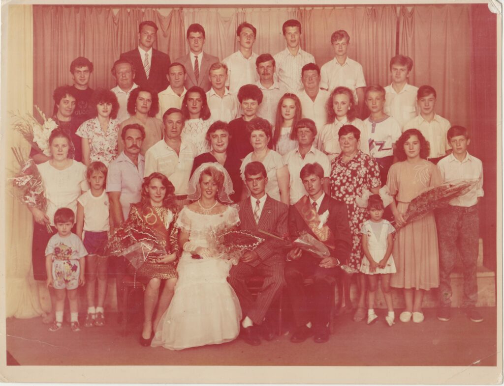 A nostalgic sepia-toned group photo of a wedding gathering from Ukraine in the late 20th century.