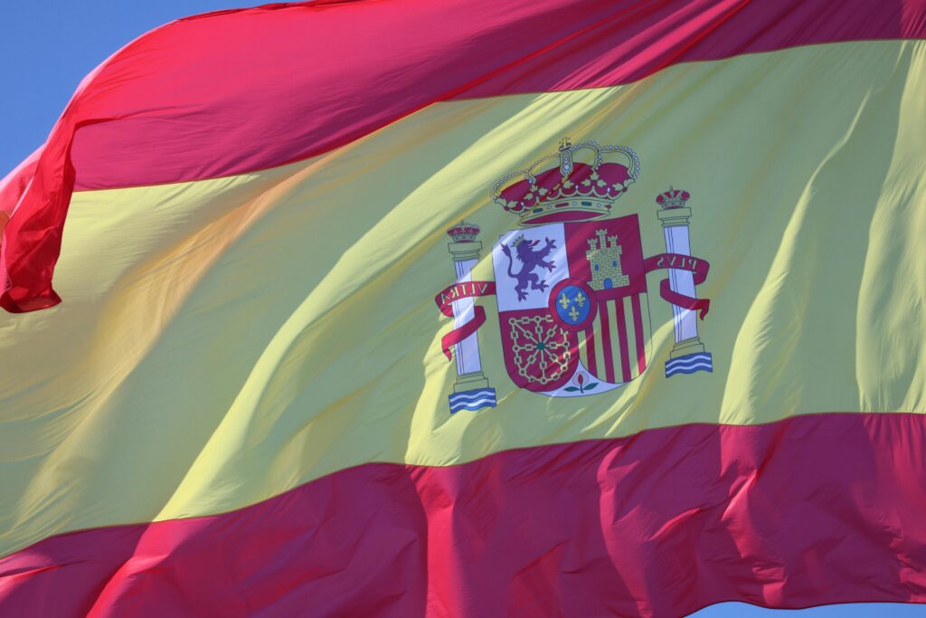 A vibrant Spanish flag waving outdoors in Cádiz, Andalucía, showcasing national pride.